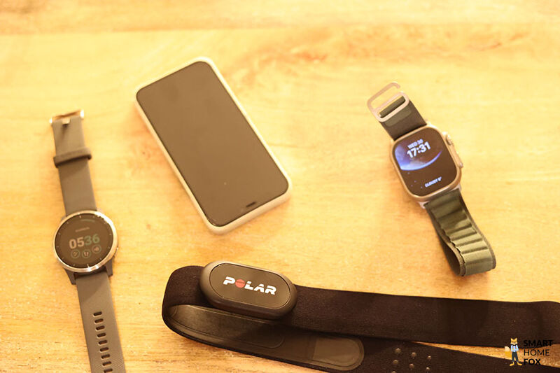 Man sieht die iWatch Ultra mit einem iPhone, der Garmin vivoactive4 und einem Brustgurt.